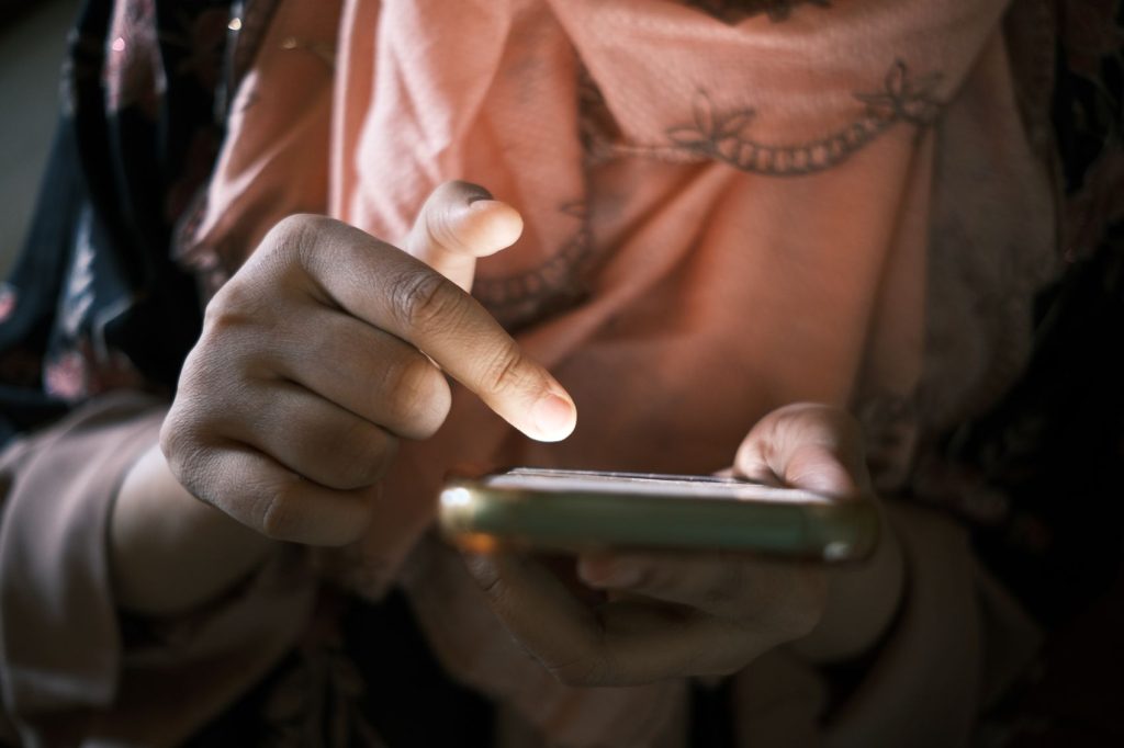 A person making a payment on a mobile phone