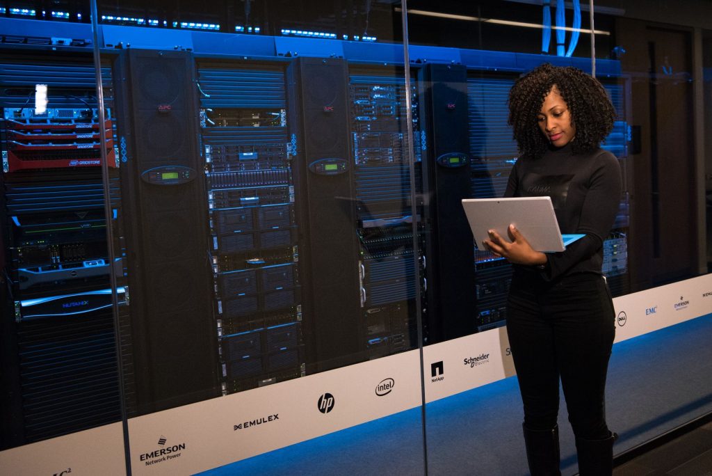 A TecFlax engineer reviewing systems on a tablet in a data centre